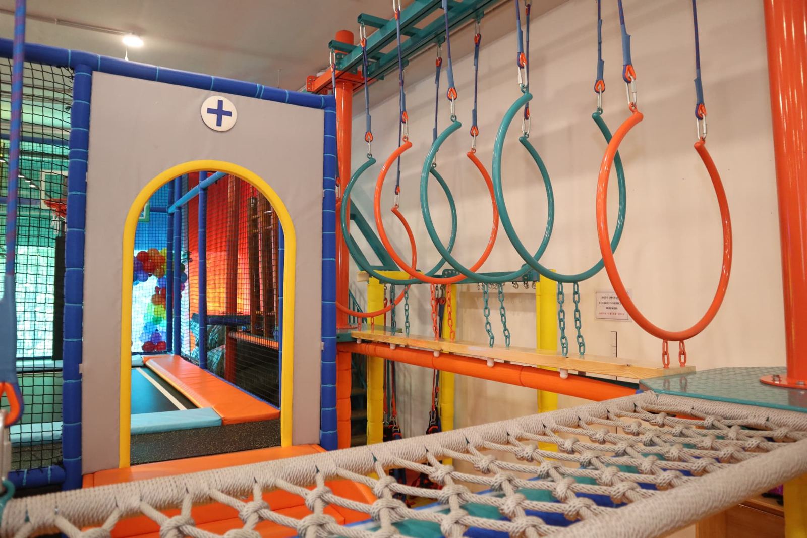 Hanging rings and a rope net bridge in the play structure at Baccha Party Vashi