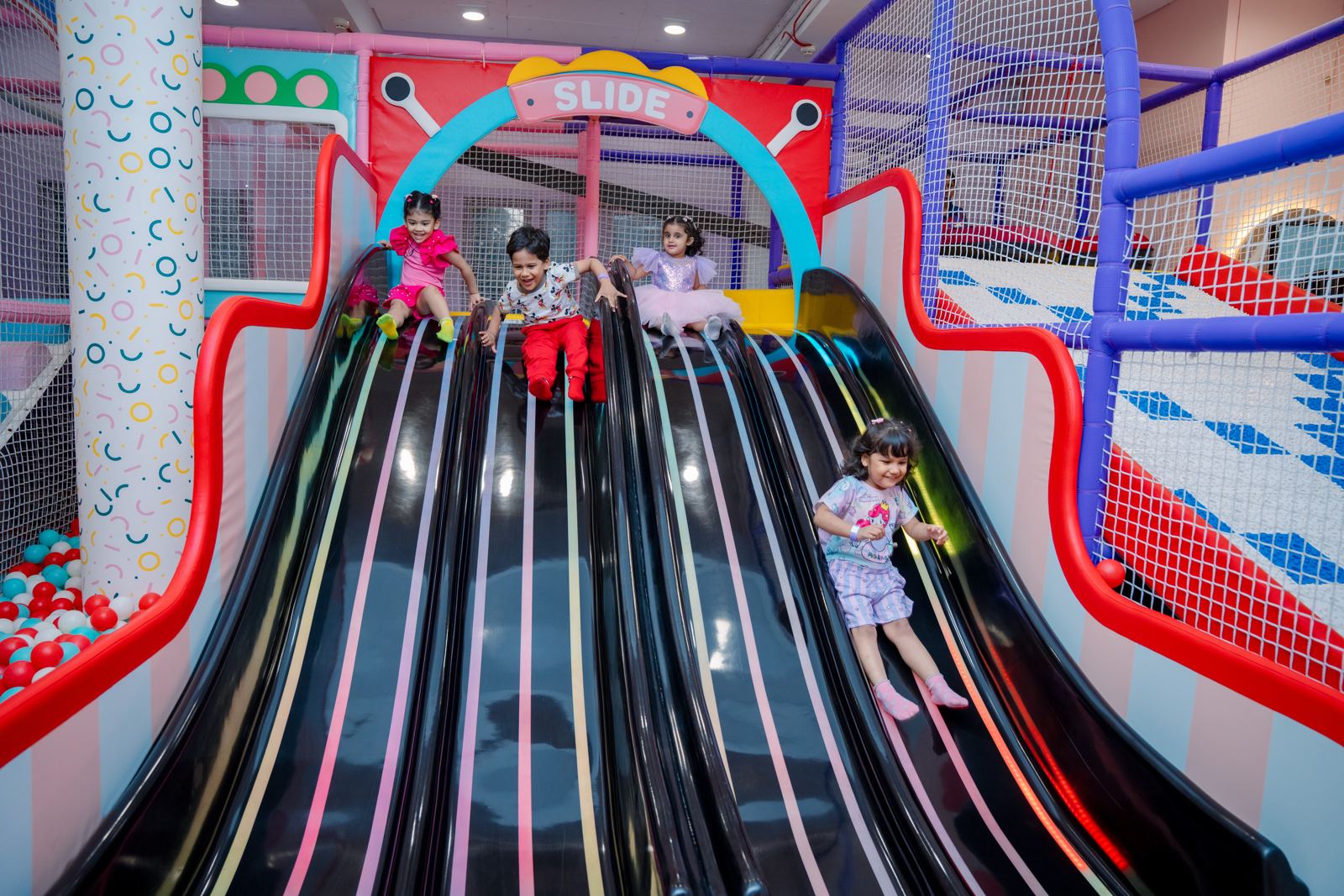 Children racing down the wave slides at Baccha Party Matunga