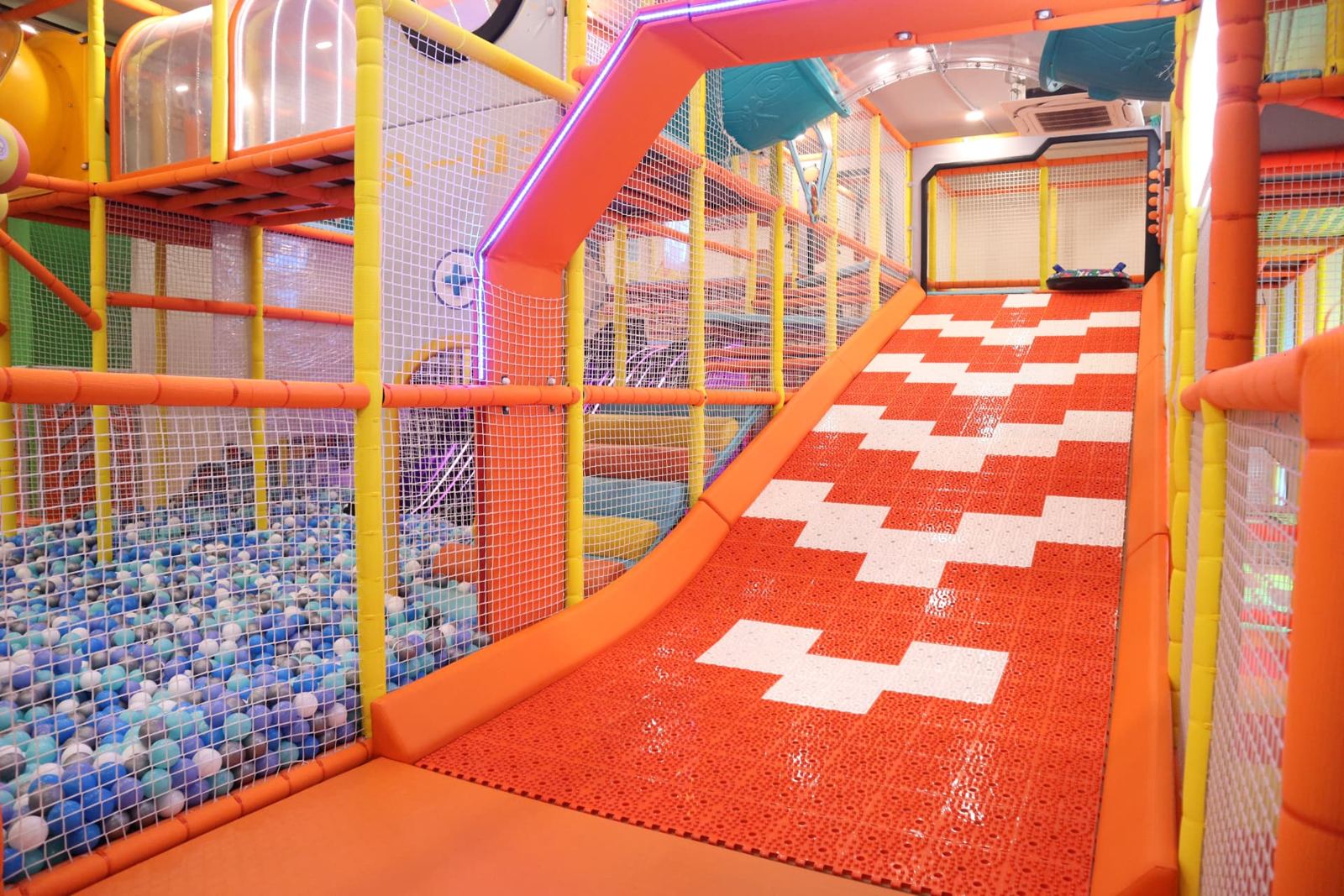 Wide orange slide inside the play structure at Baccha Party Vashi