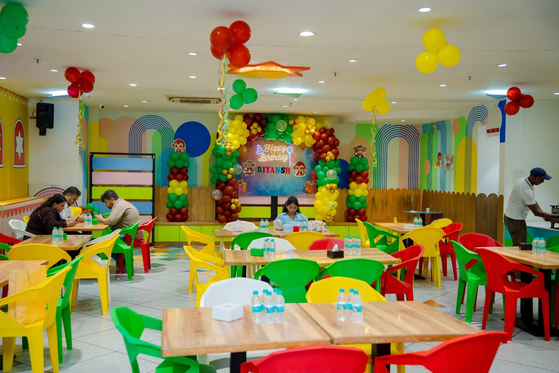 Party hall decorated with balloons and colourful tables at Baccha Party Powai