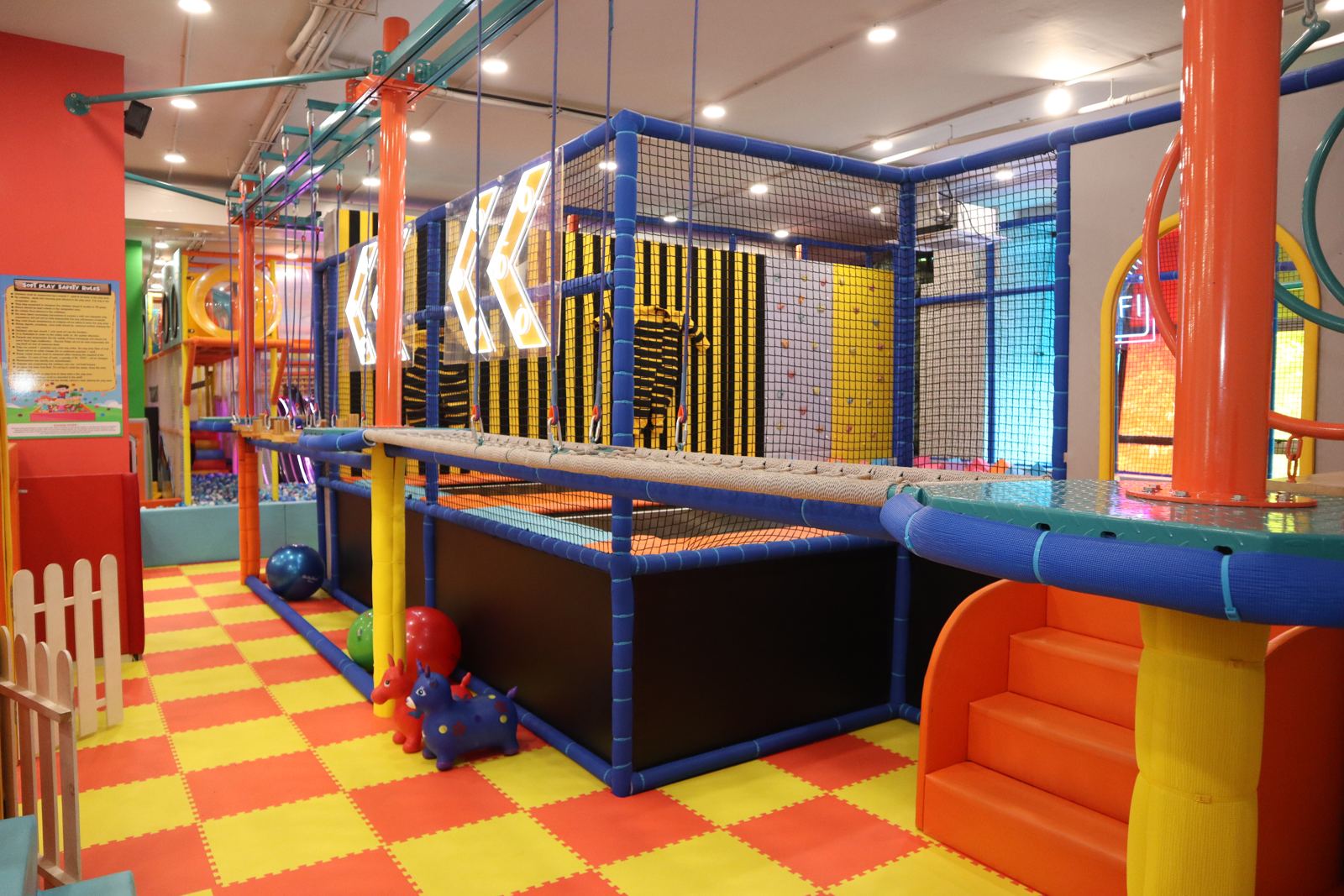 Toddler zone with soft steps below the play structure at Baccha Party Vashi