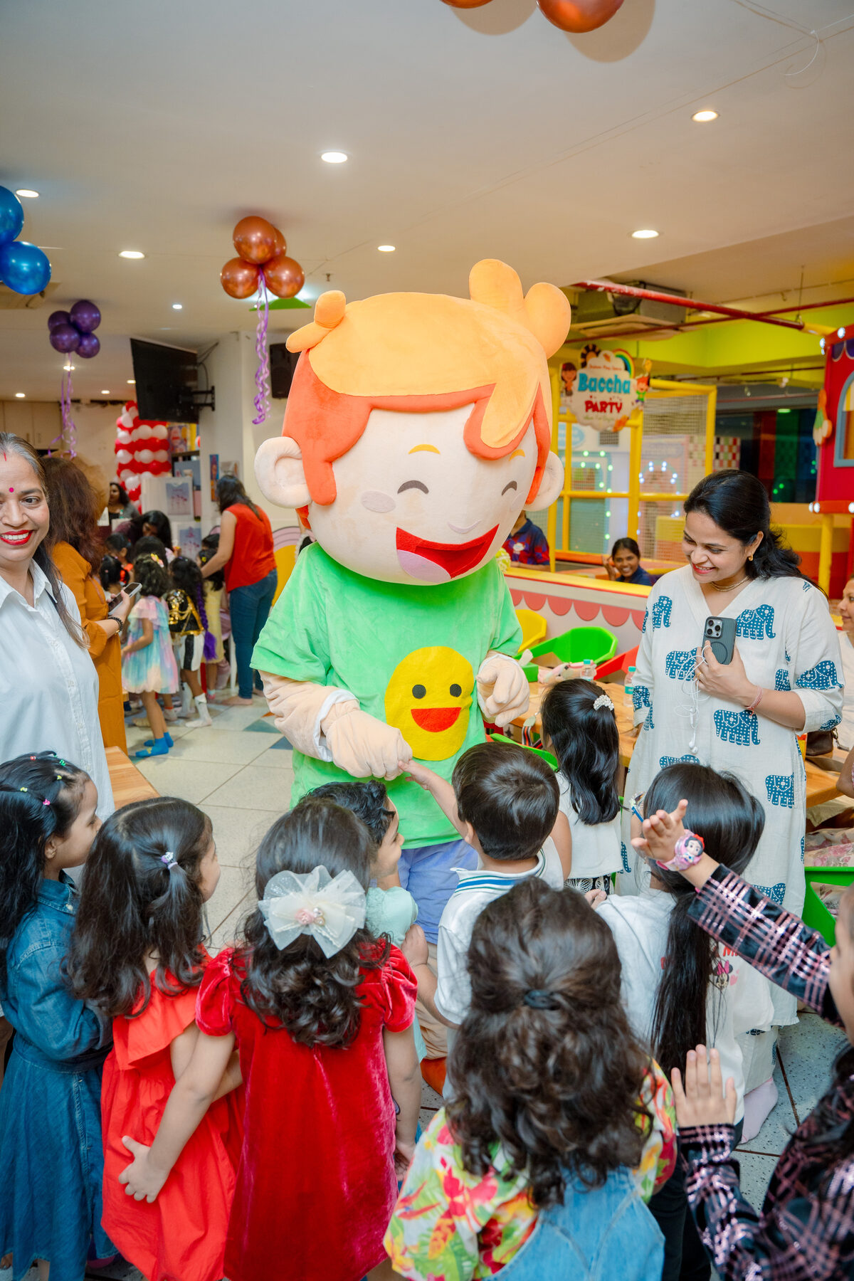 Baccha Party mascot greeting a group of children at a birthday celebration in Powai