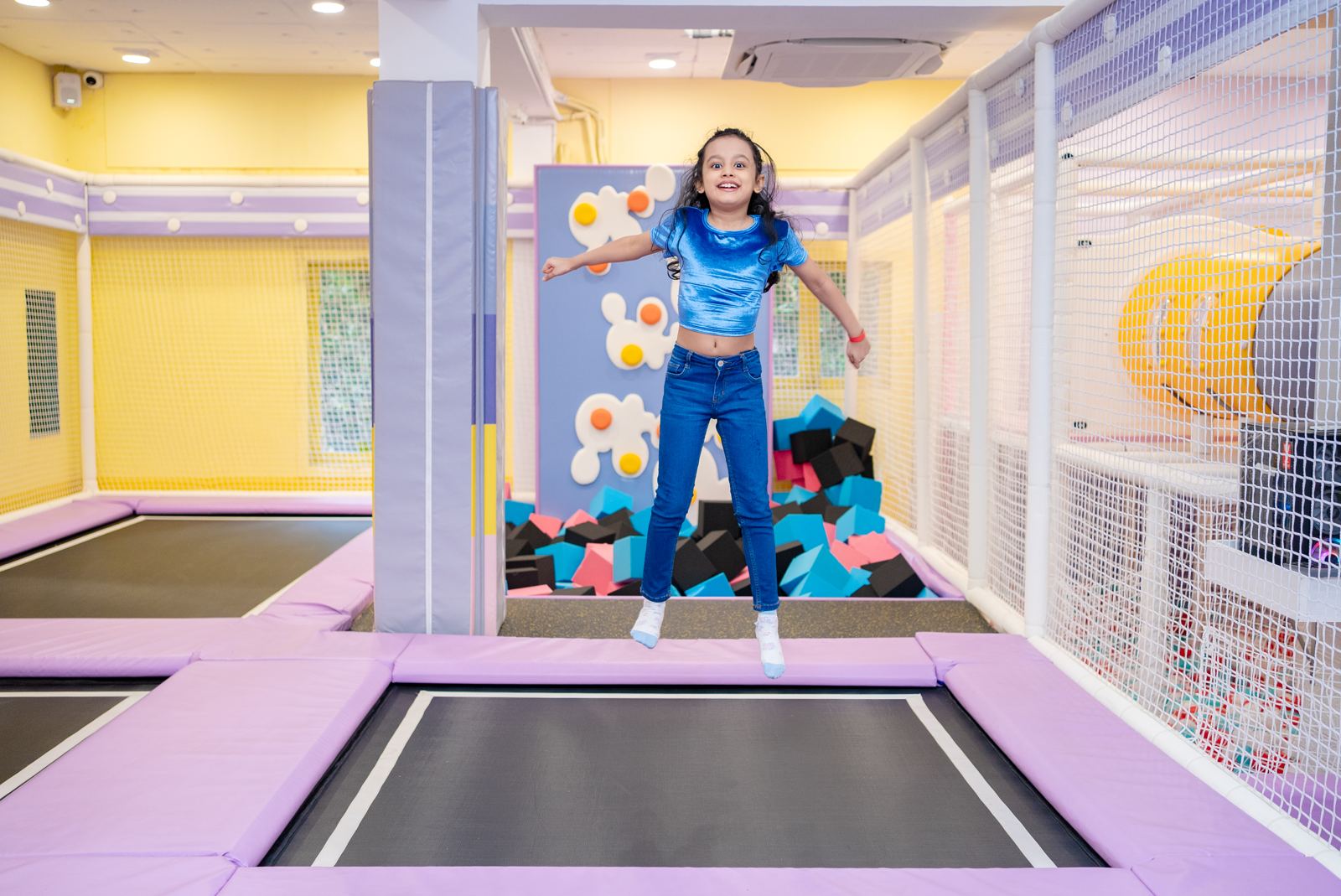 Girl jumping in the trampoline zone at Baccha Party Matunga