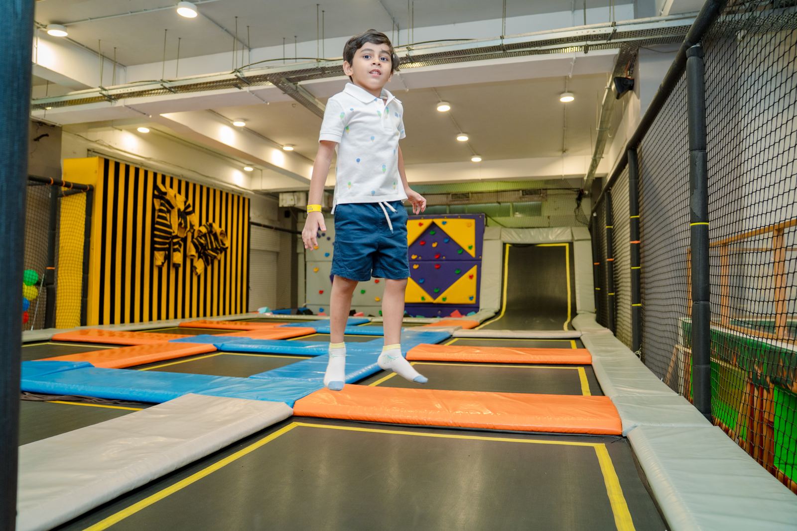 Boy bouncing in the trampoline arena at Baccha Party Malad