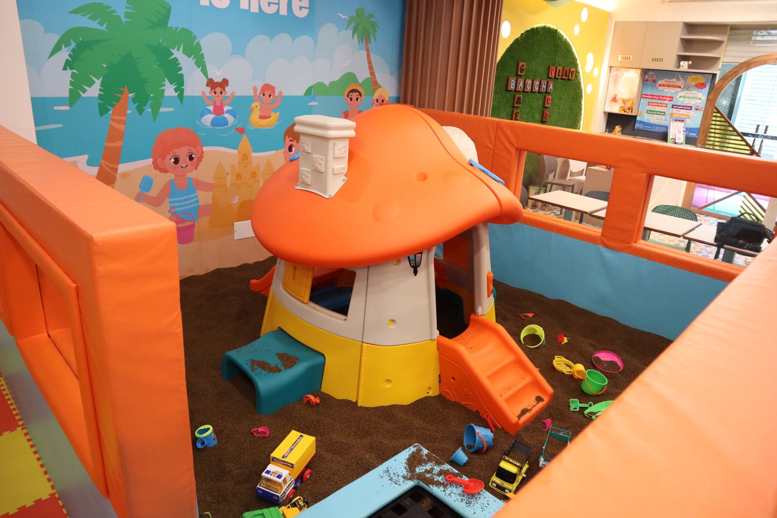 Toddler sand play area with a mushroom playhouse at Baccha Party Vashi
