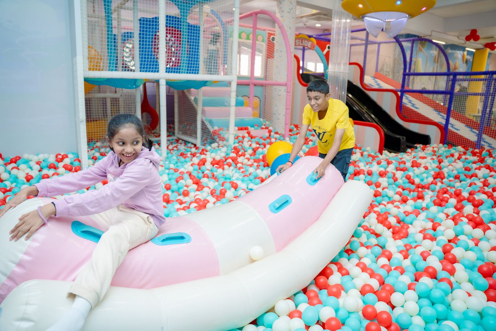 Children riding the inflatable in the ball pit at Baccha Party Matunga