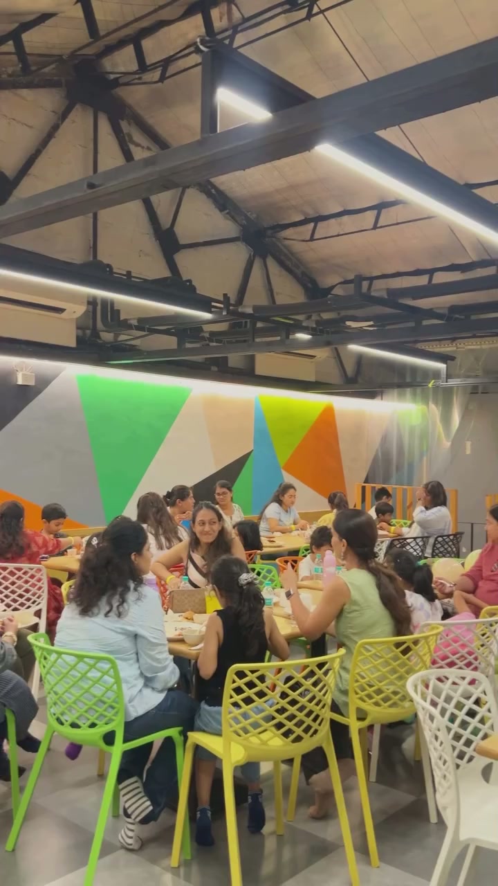 Families sharing a birthday meal around colourful tables at Baccha Party Thane